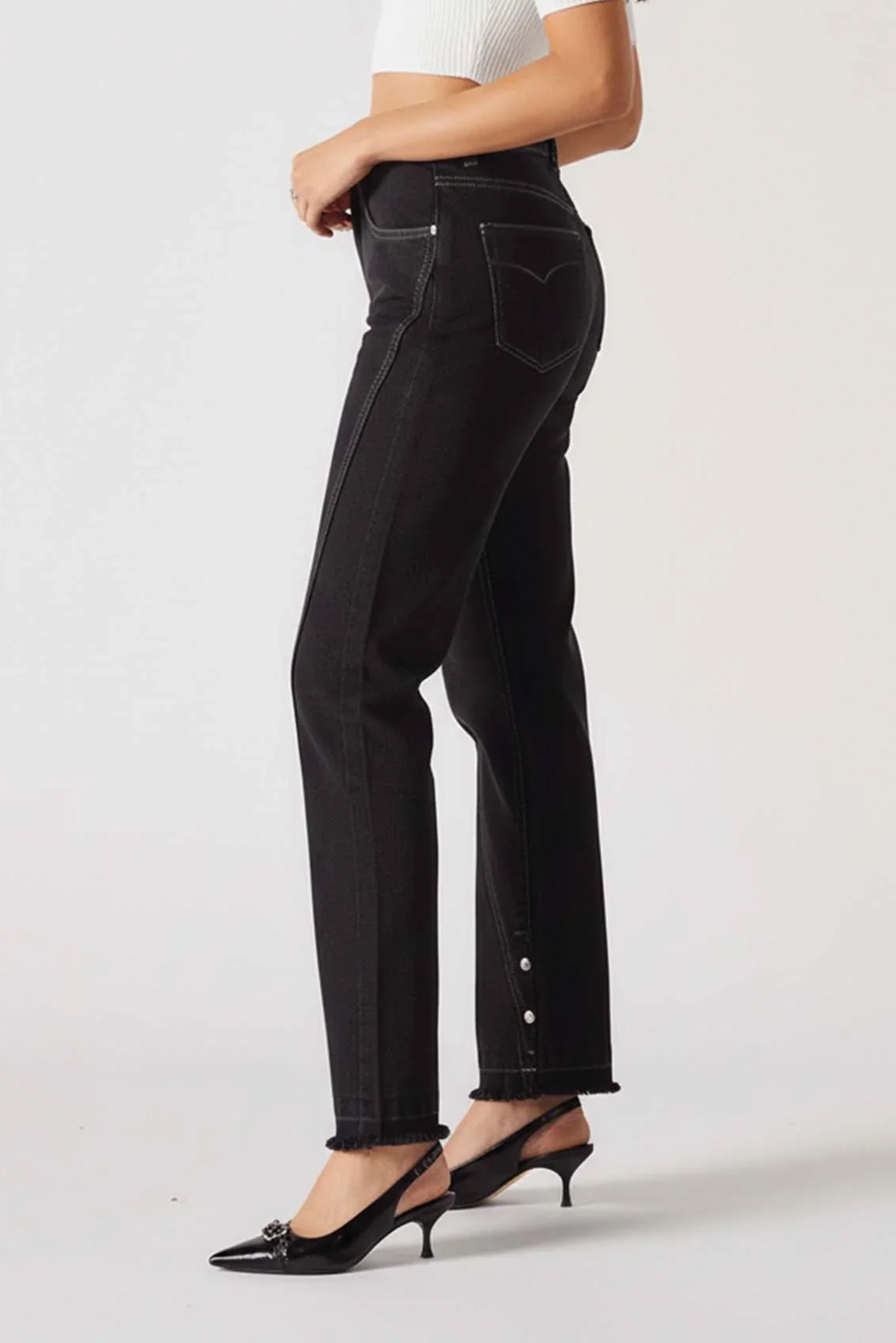 Person wearing black jeans on a white background
