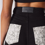 Close up texture view of the silver rhinestone embellishments on the back pockets