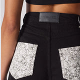 Close up texture view of the silver rhinestone embellishments on the back pockets