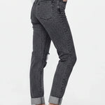 Person wearing black jeans with a white background