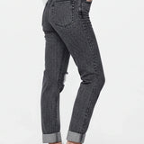 Person wearing black jeans with a white background