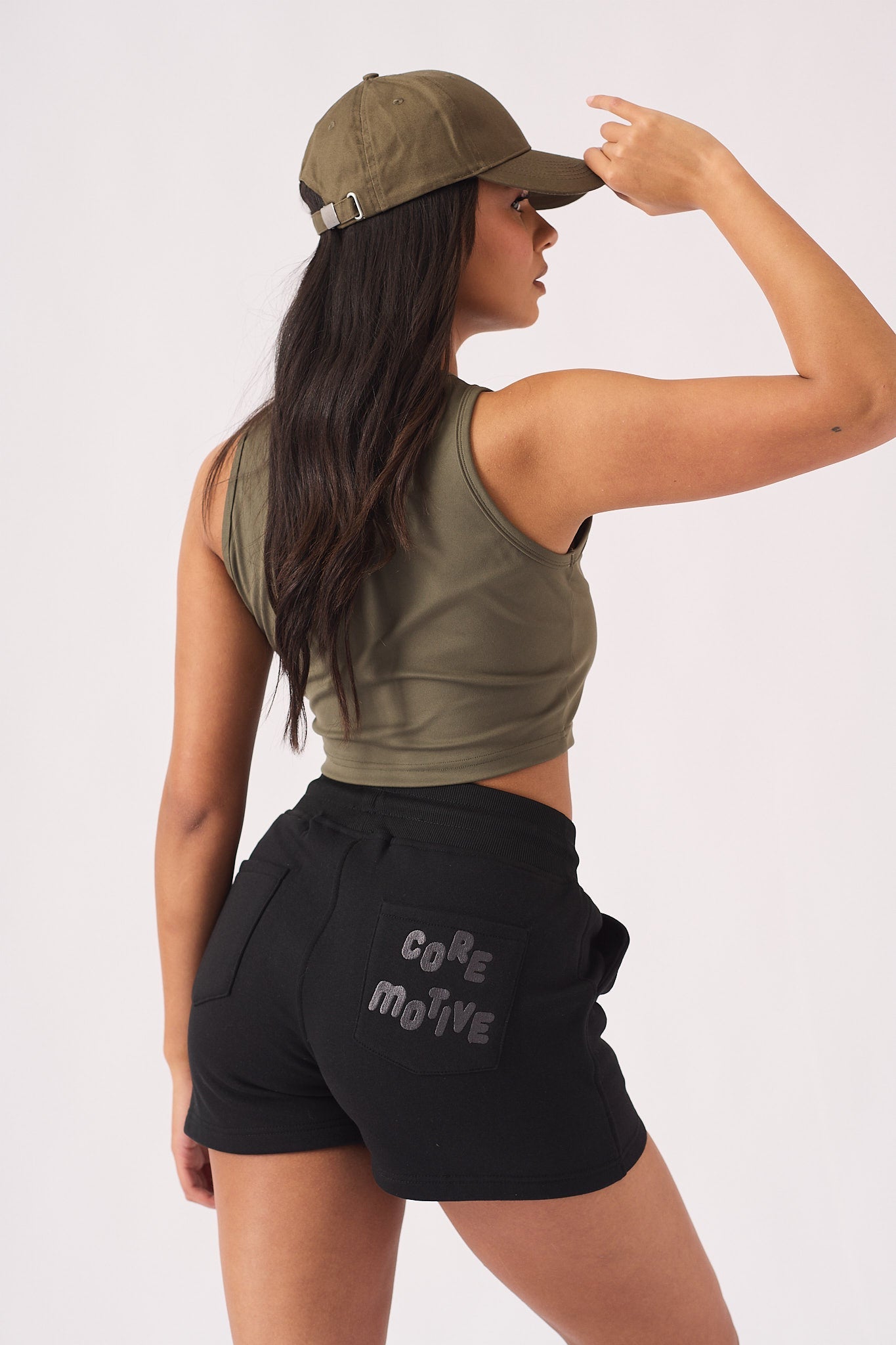 Close up side view of the tonal embroidered logo on black jogger shorts