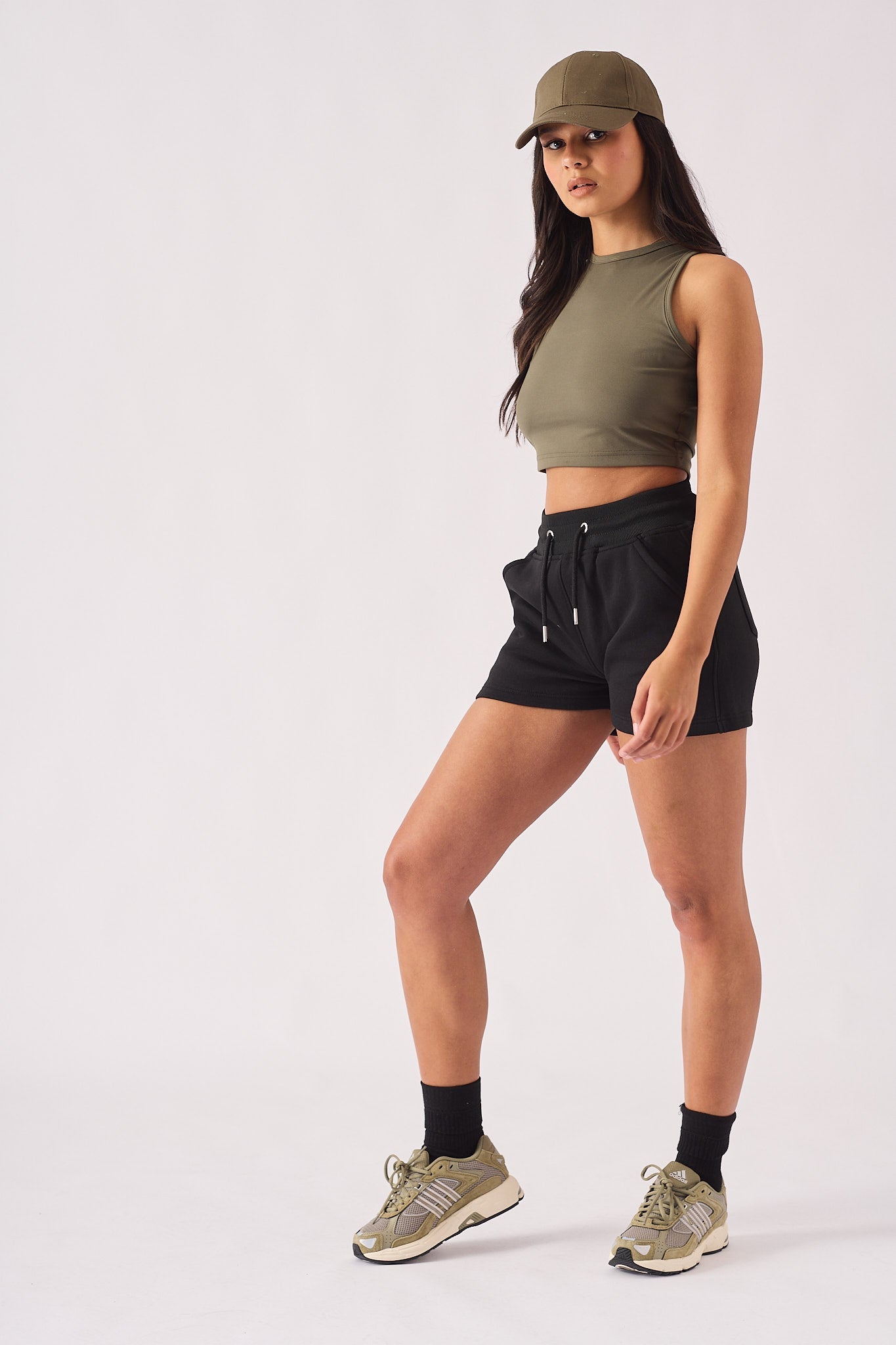 Side profile view of a model styling comfortable black jogger shorts