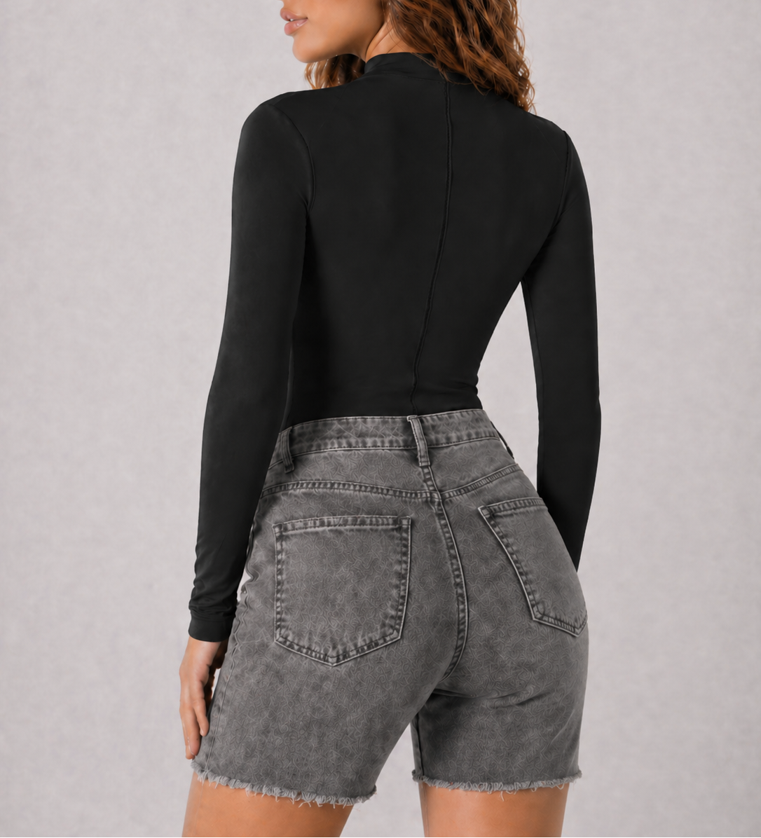 A woman wearing womens-black-mock-neck-bodysuit back view showing the fitted long sleeve and smooth back panel