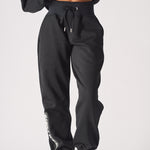 Full front shot of the relaxed black oversized joggers womens from the waist down.