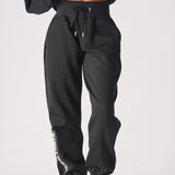Full front shot of the relaxed black oversized joggers womens from the waist down.