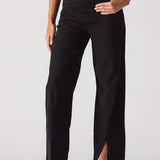 Black pants with a high slit worn by a model on a white background