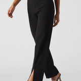 Black pants with silver accents worn by a model on a white background