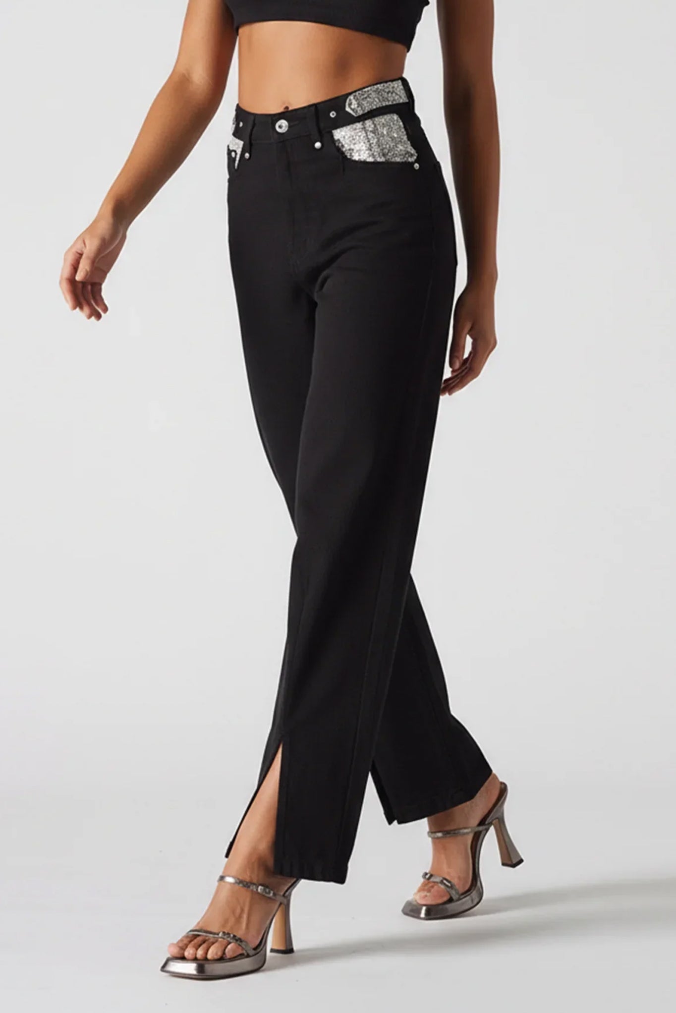 Black pants with silver accents worn by a model on a white background