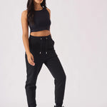 Model posing in black pintuck jogger womens casual style
