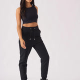 Model posing in black pintuck jogger womens casual style