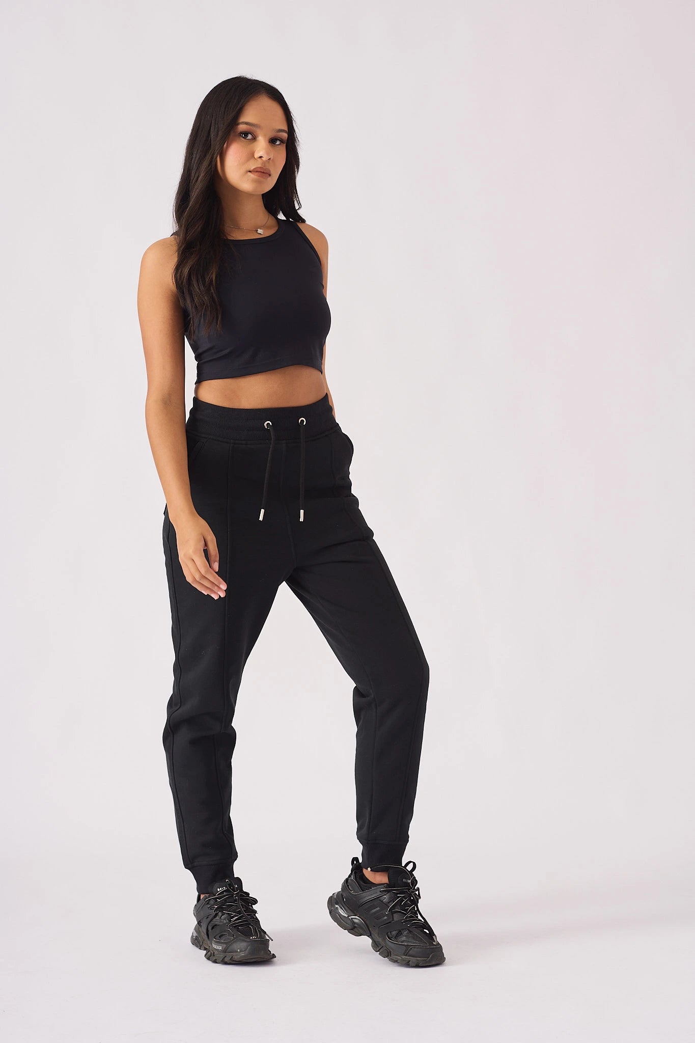 Model posing in black pintuck jogger womens casual style