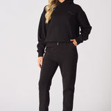 Rear view of a black pullover hoodie showing the large white graphic print
