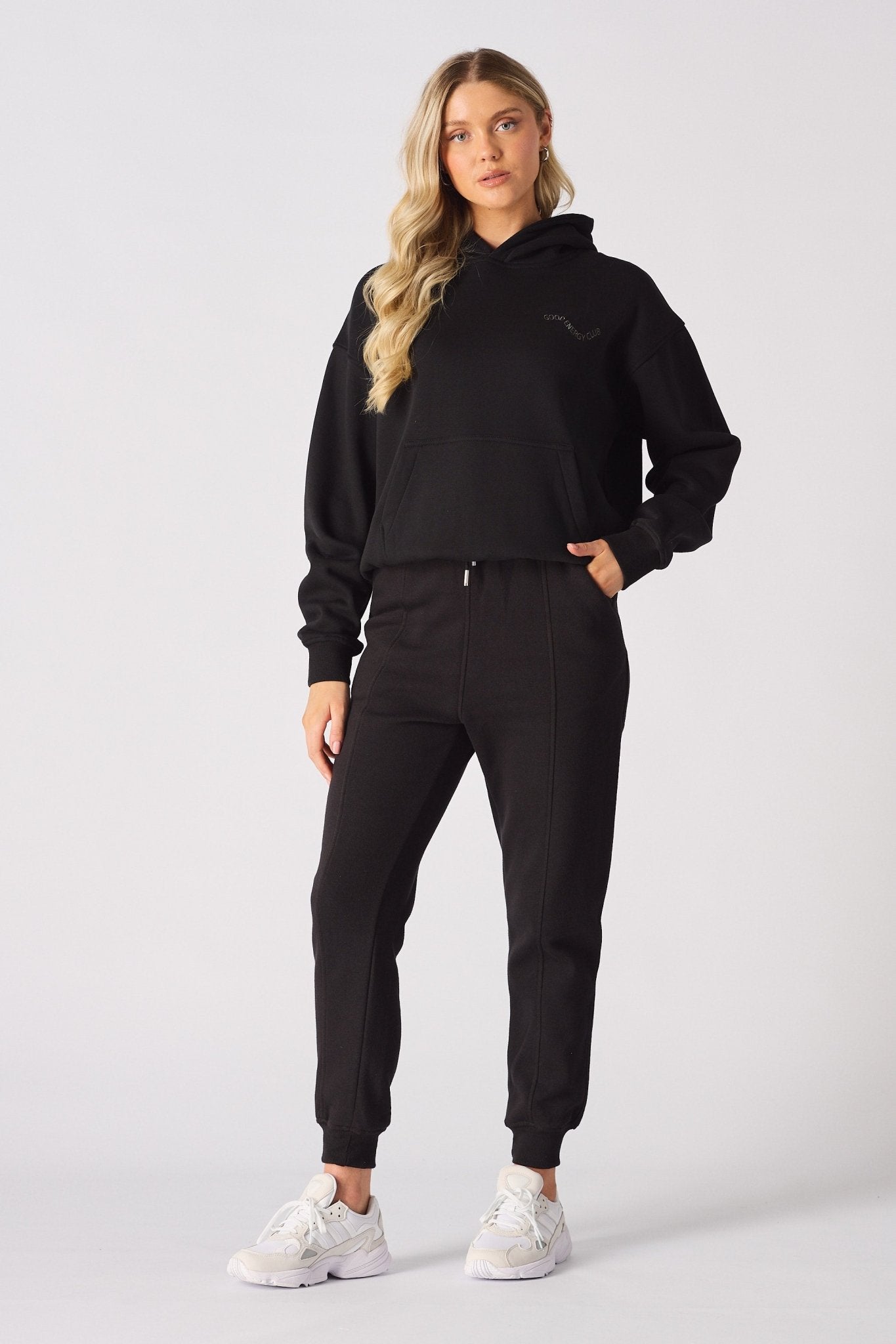 Rear view of a black pullover hoodie showing the large white graphic print