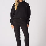 Detailed view of the tonal embroidery on a black pullover hoodie