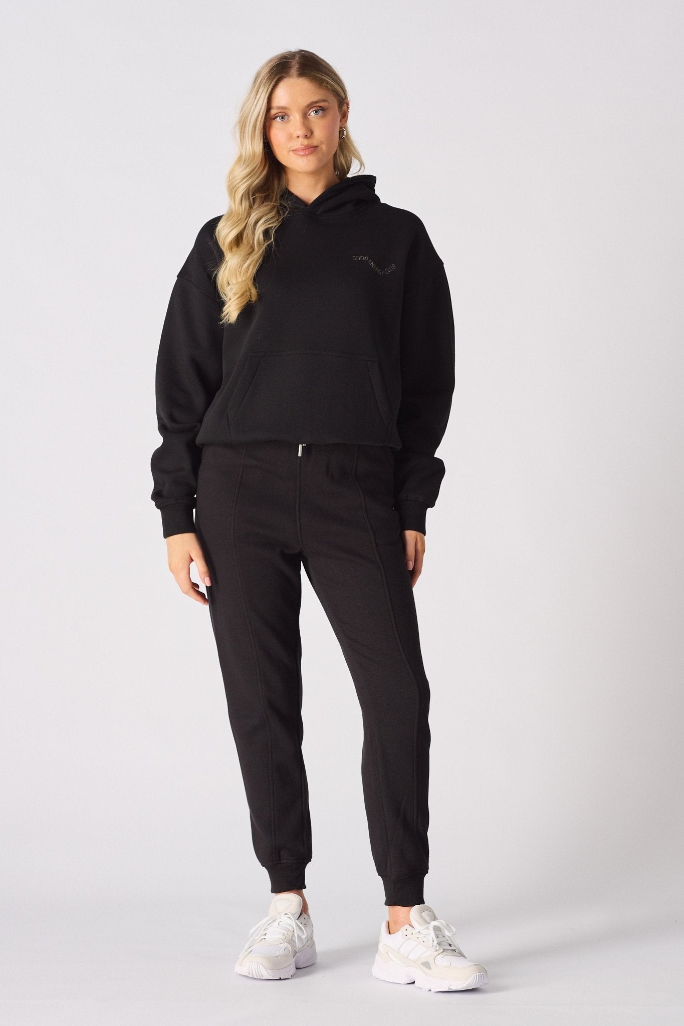 Detailed view of the tonal embroidery on a black pullover hoodie