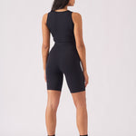 Rear view of a woman wearing a black racer neck crop top showing the athletic design