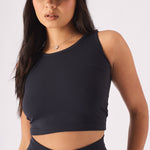 Close up front view of a fitted black racer neck crop top for women