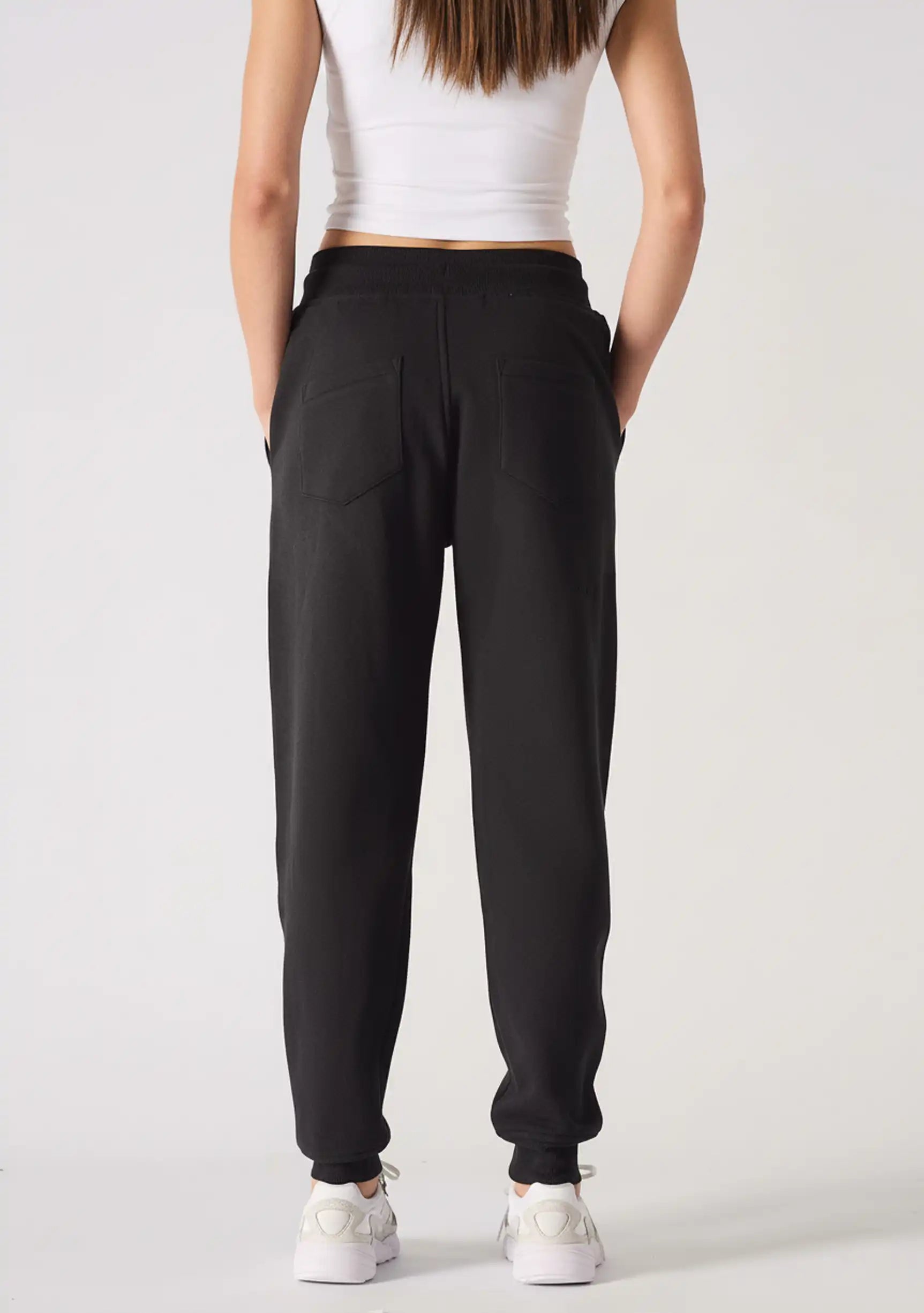 Rear view showing the clean fit and silhouette of these black relaxed fit joggers womens.