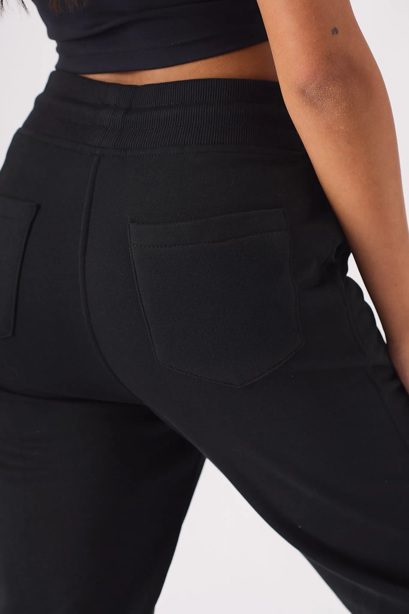 Detailed close up of the back pocket texture on black relaxed jogger