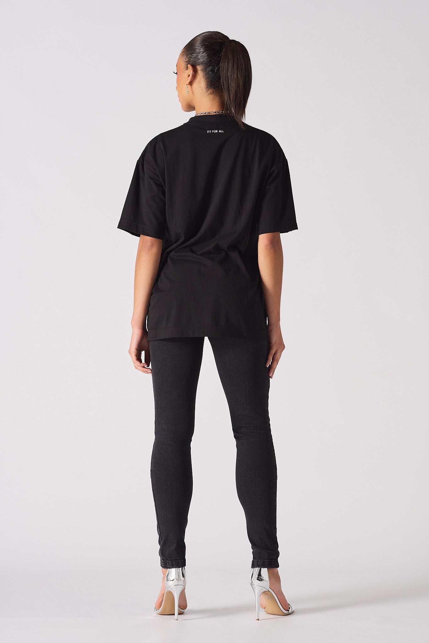black skinny biker jeans women back view styled with oversized t-shirt