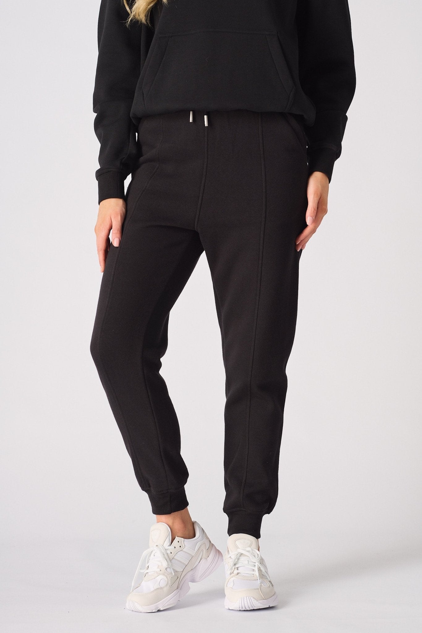 Front shot from the waist down of the smart black tapered joggers womens.