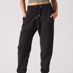 Front view of the black tapered joggers for women, showing the logo and fit.