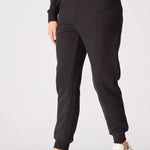 Close up view of the tapered leg and cuff on these black tapered joggers womens.