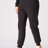 Close up view of the tapered leg and cuff on these black tapered joggers womens.
