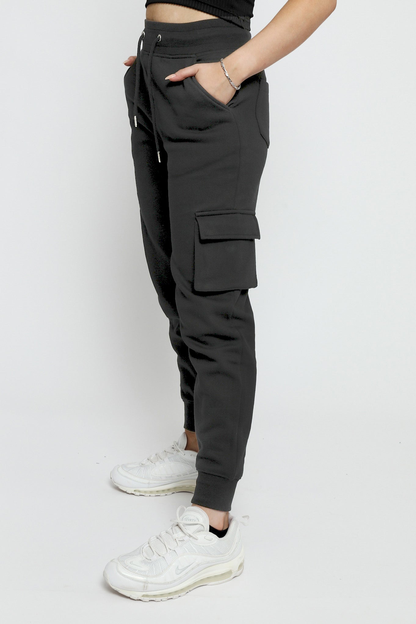 Close side view of black utility joggers womens showing the pocket detail.