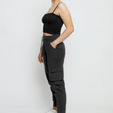 Side profile of a model wearing the relaxed fit black utility joggers womens.