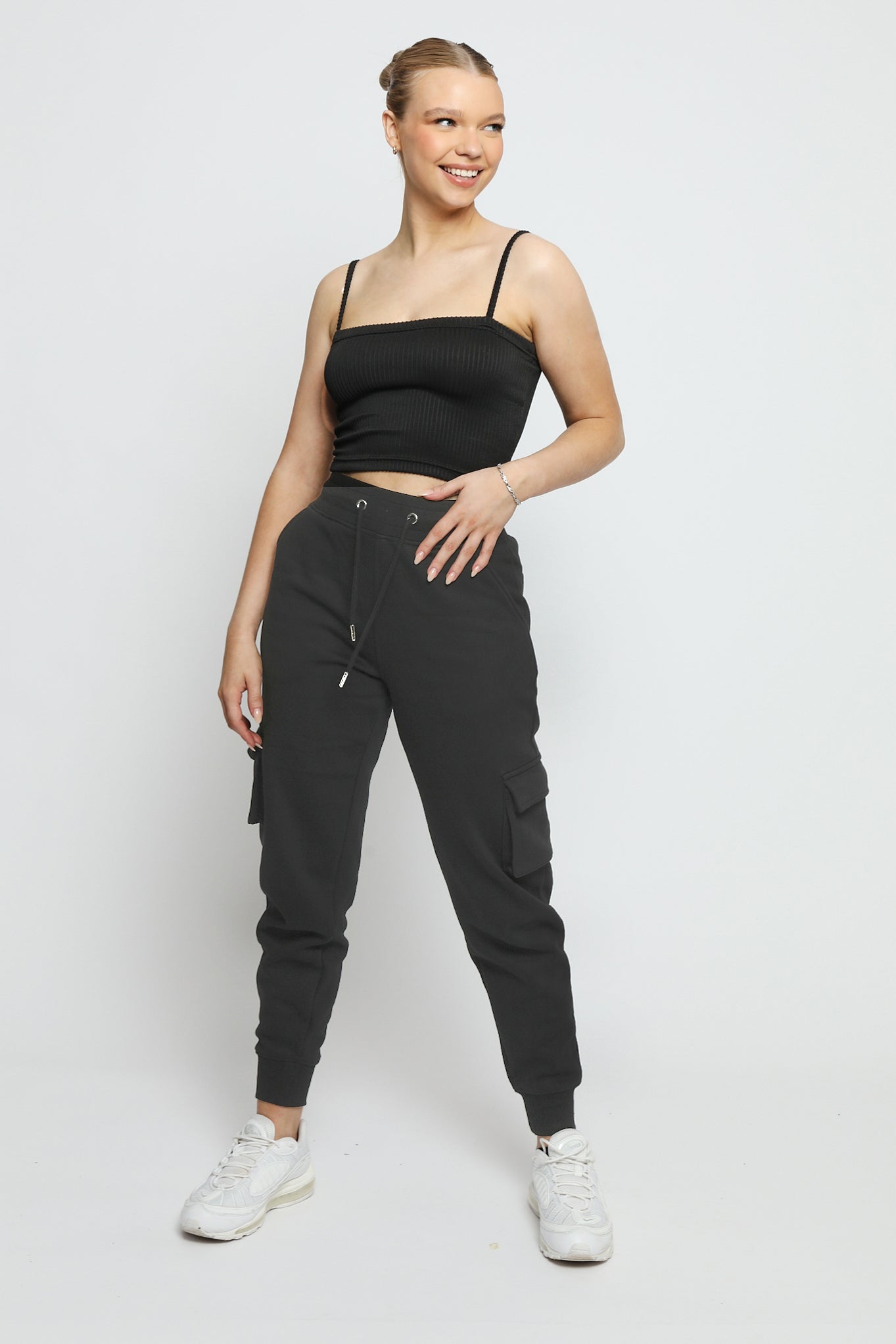 A woman walking comfortably while wearing black utility joggers womens.