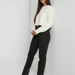 Model leaning against the wall wearing Black Wash Curved Seam Straight Leg Jeans