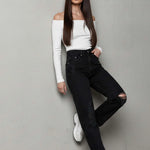 Model leaning against a wall wearing Black Wash Relaxed Straight Jeans For Women