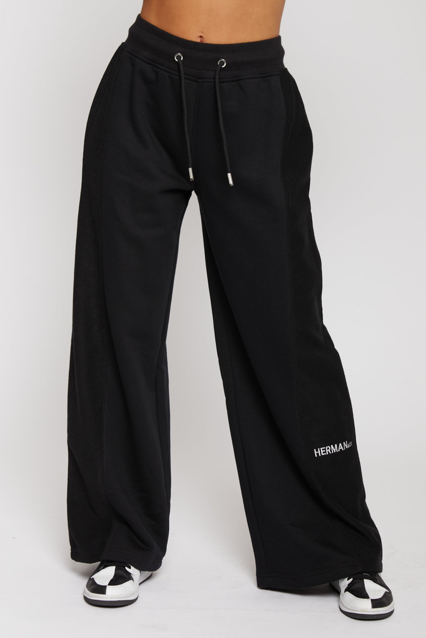 Close up front view of black wide leg joggers for women with a drawstring waist