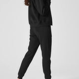 Rear view showing the relaxed oversized fit and hood of the black zip up hoodie womens.