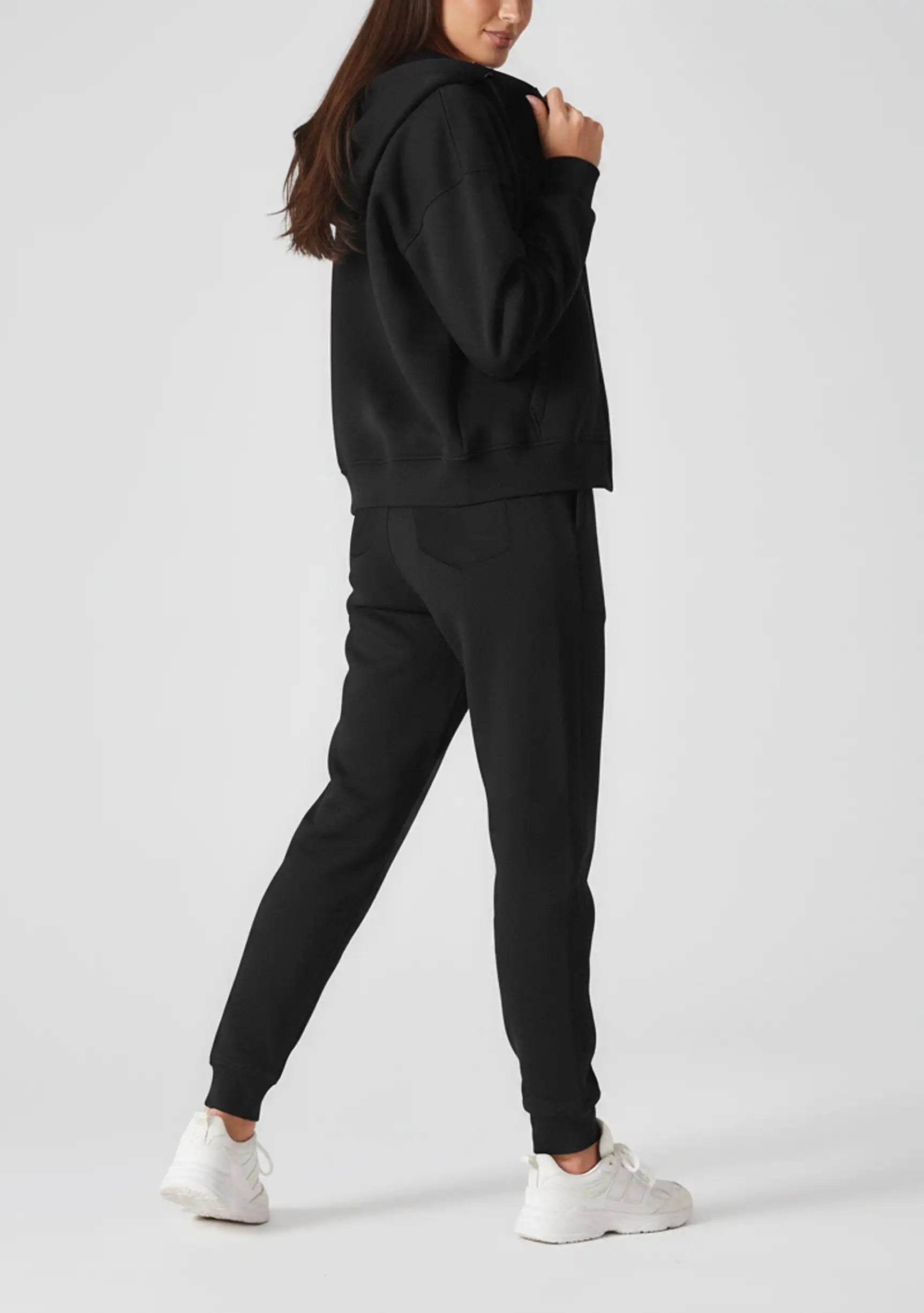 Rear view showing the relaxed oversized fit and hood of the black zip up hoodie womens.