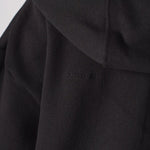 Detailed shot of the soft premium fabric and hood of the black zip up hoodie womens.