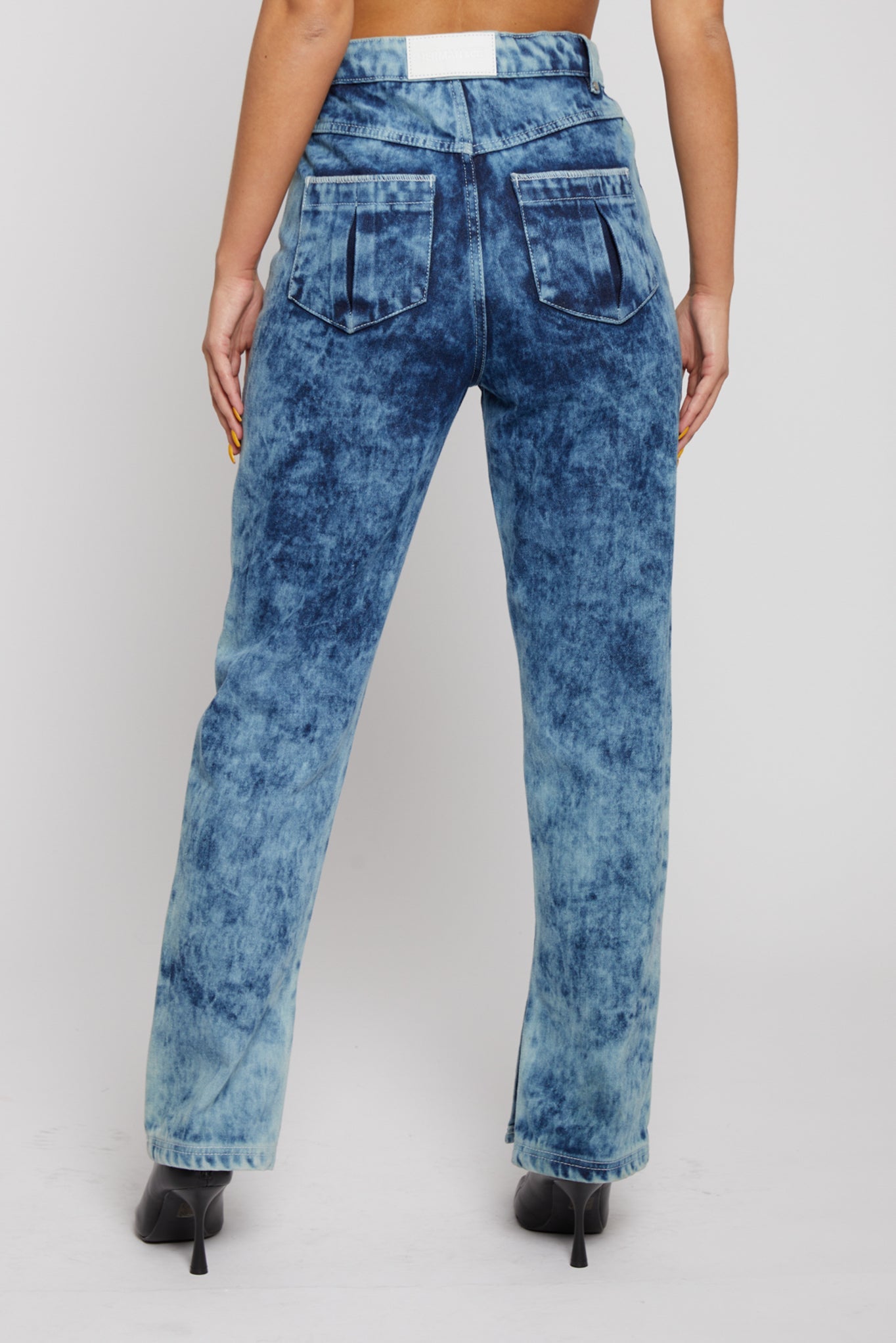 Back view showing patch pockets on bleach wash straight-leg jeans