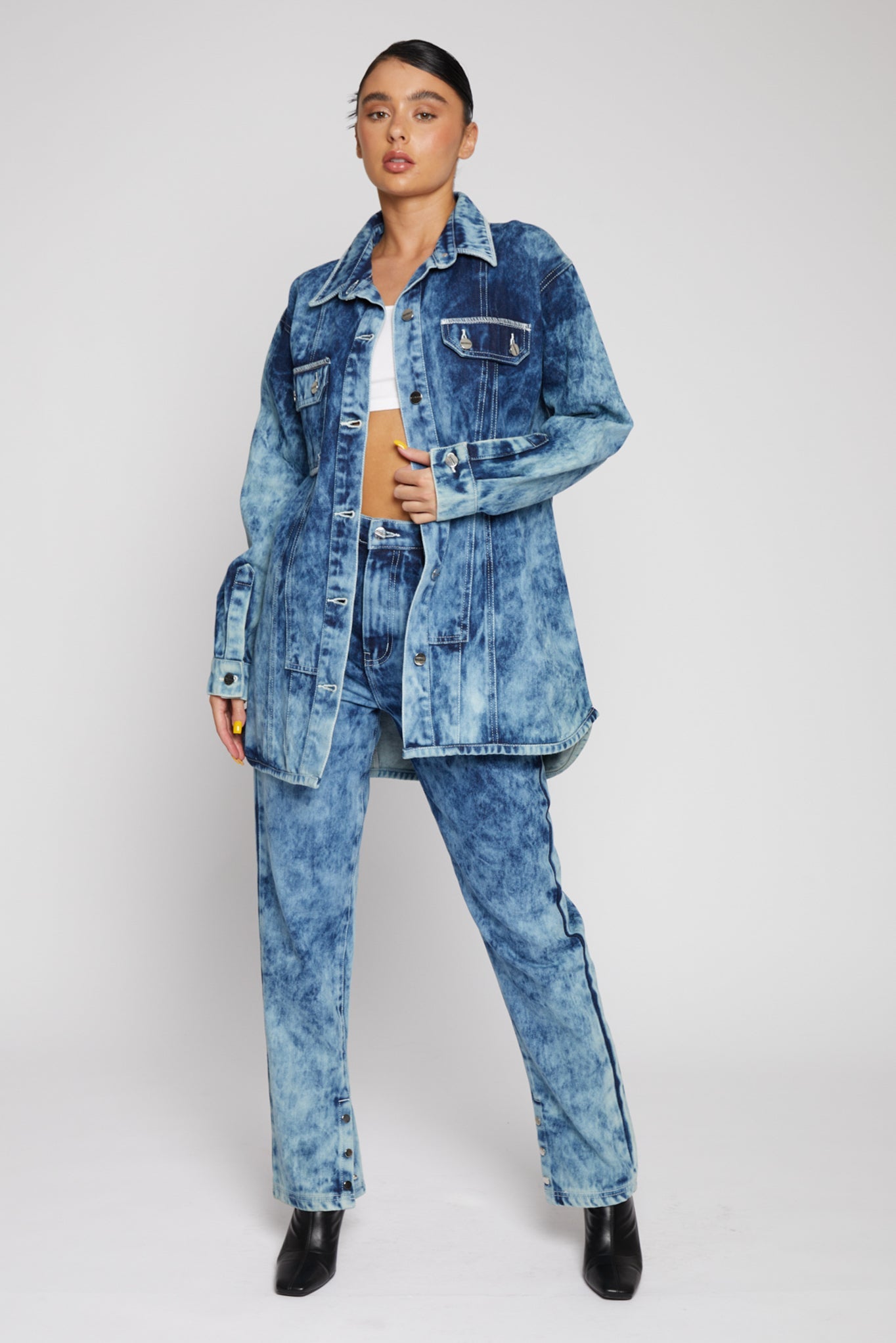 Woman wearing bleach wash straight-leg jeans with matching denim jacket
