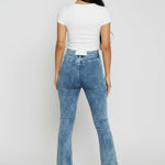 Back view of women's blue acid wash jeans featuring a pocketless design