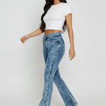 Side profile view of women's blue acid wash bootcut denim