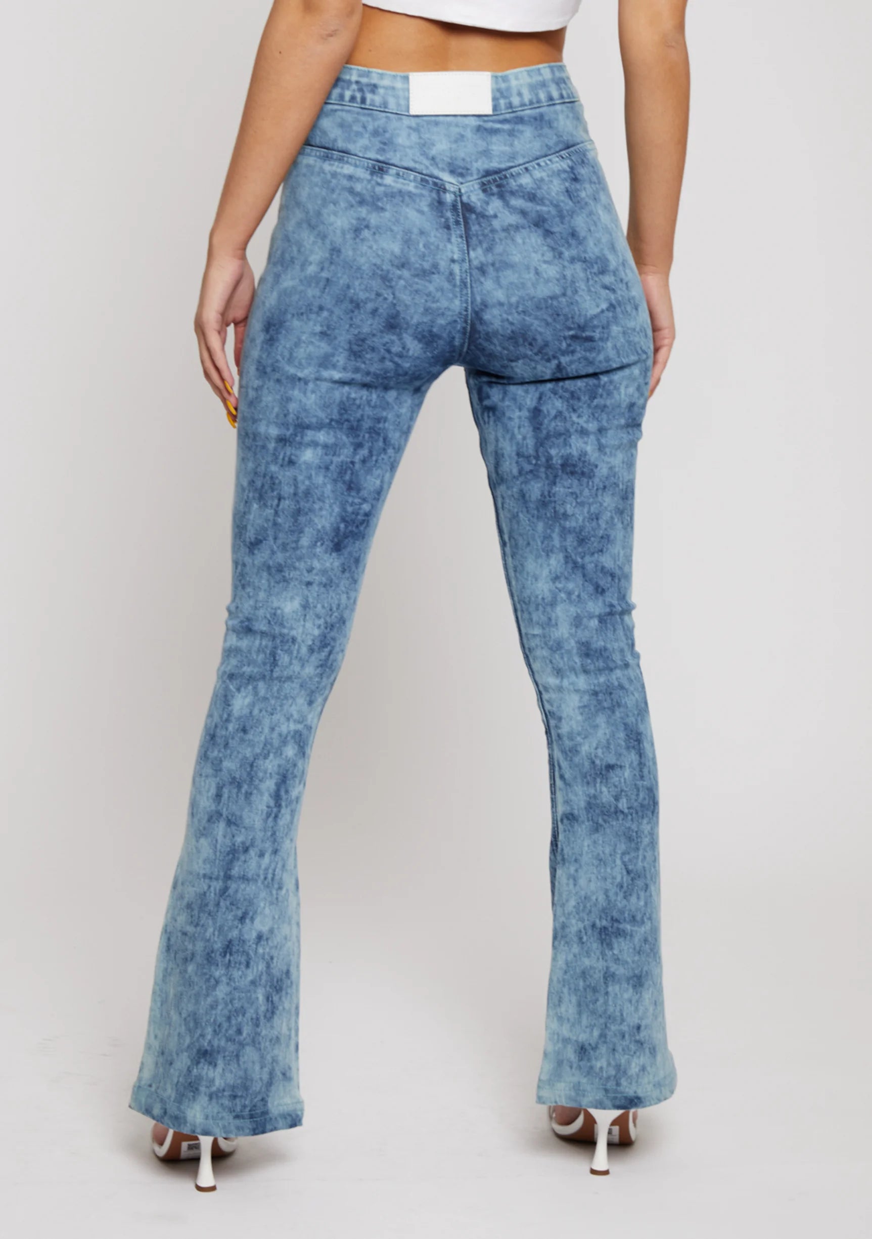 Close up back view of blue acid wash jeans showing pocketless design