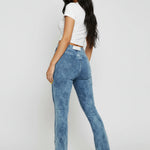 Full front view of a model in trendy blue acid wash bootcut jeans