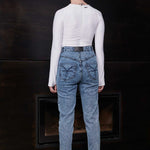 Back view of a model wearing the blue acid wash skinny jeans, showing pocket details