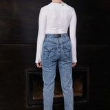Back view of a model wearing the blue acid wash skinny jeans, showing pocket details