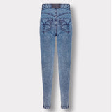 Back view of the blue acid wash skinny jeans with logo patch, laid flat