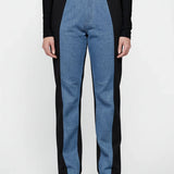 Blue and black pants worn by a person on a white background