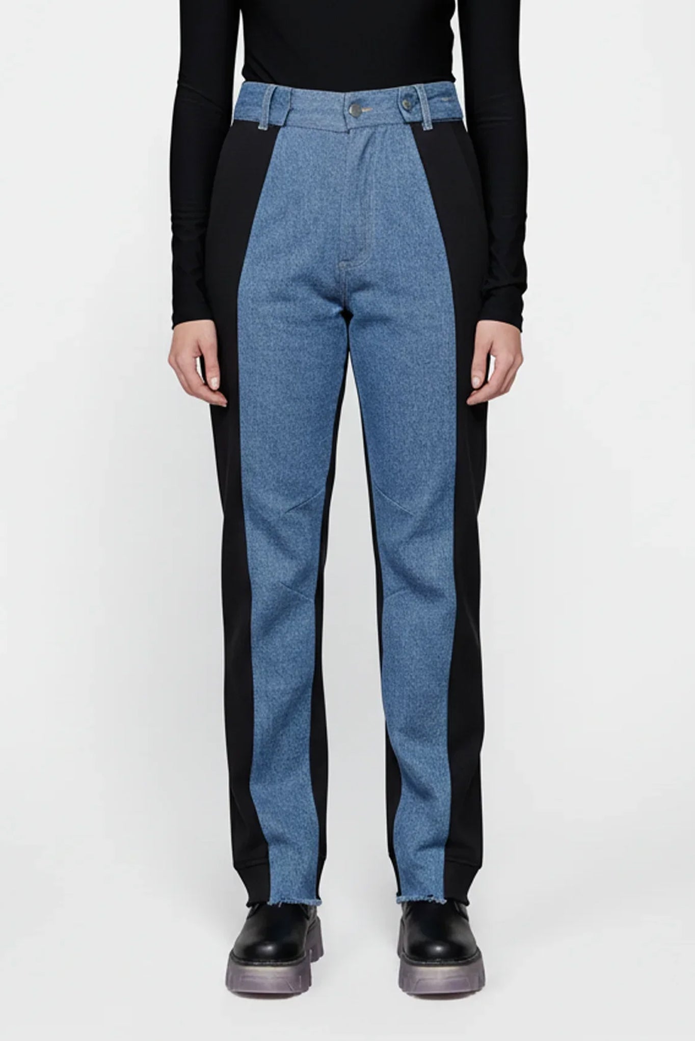 Blue and black pants worn by a person on a white background