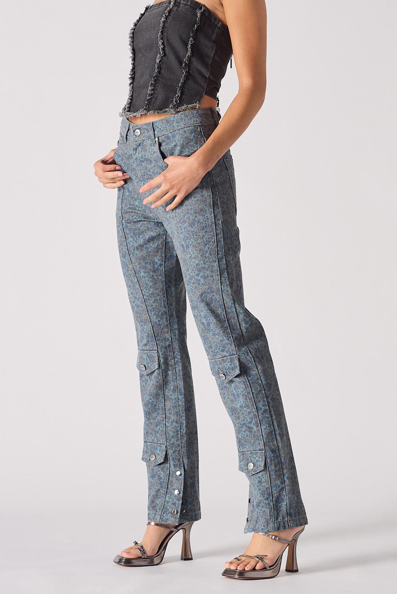 Person wearing blue denim cargo pants on a white background